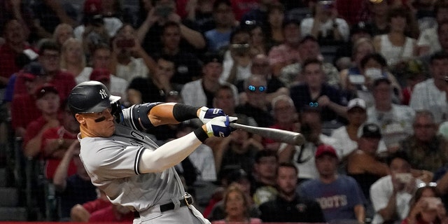 New York Yankees' Aaron Judge hits a three-run home run during the fourth inning against the Los Angeles Angels on Aug. 30, 2022, in Anaheim, California.