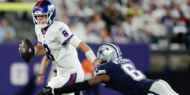 New York Giants quarterback Daniel Jones (8) tries to avoid a tackle from Dallas Cowboys safety Donovan Wilson during the second quarter on Sept. 26, 2022, in East Rutherford, New Jersey.
