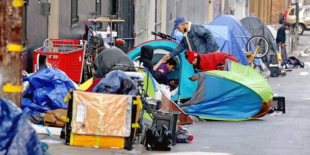 SAN FRANCISCO, CA - FEBRUARY 24: Homeless people consume illegal drugs in an encampment along Willow St. in the Tenderloin district of downtown on Thursday, Feb. 24, 2022 in San Francisco, CA. London Breed, mayor of San Francisco, is the 45th mayor of the City and County of San Francisco. She was supervisor for District 5 and was president of the Board of Supervisors from 2015 to 2018. 