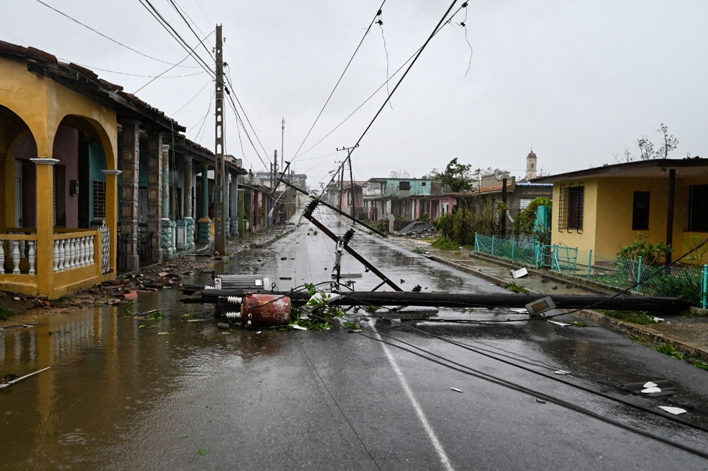 A downed utility pole lies on the street in Consolacion del Sur, Cuba.