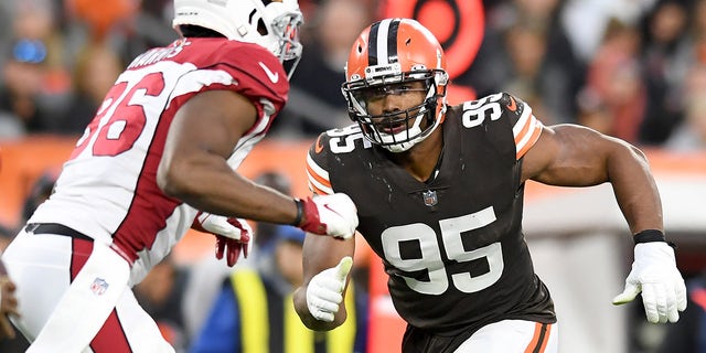 Myles Garrett (95) of the Cleveland Browns rushes at Demetrius Harris of the Arizona Cardinals during the fourth quarter at FirstEnergy Stadium in Cleveland on Oct. 17, 2021.