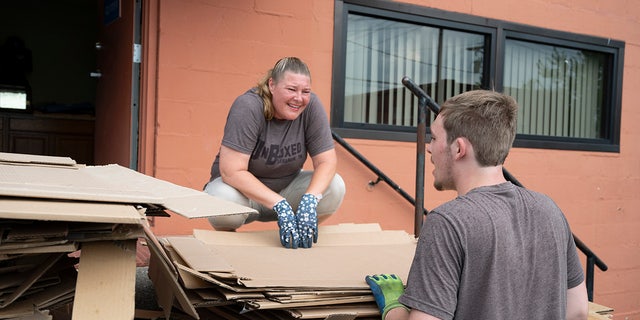 Ashton Gilbert chats with his mother, Ashley York, as they collect boxes at a local business.