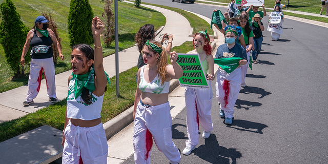 Pro-choice activists with Rise Up 4 Abortion Rights chant after marching to the home of Supreme Court Justice Amy Coney Barrett on June 18, 2022, in Falls Church, Virginia.