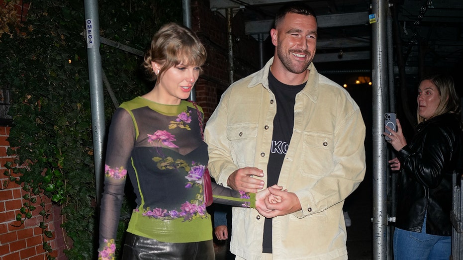 Taylor Swift and Travis Kelce holding hands